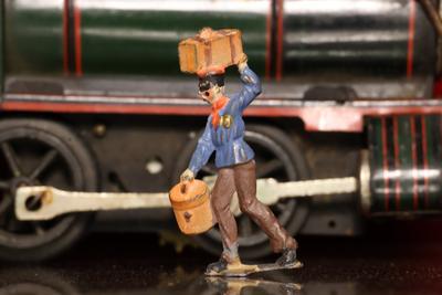 Figura de plomo: persona cargando maletas
